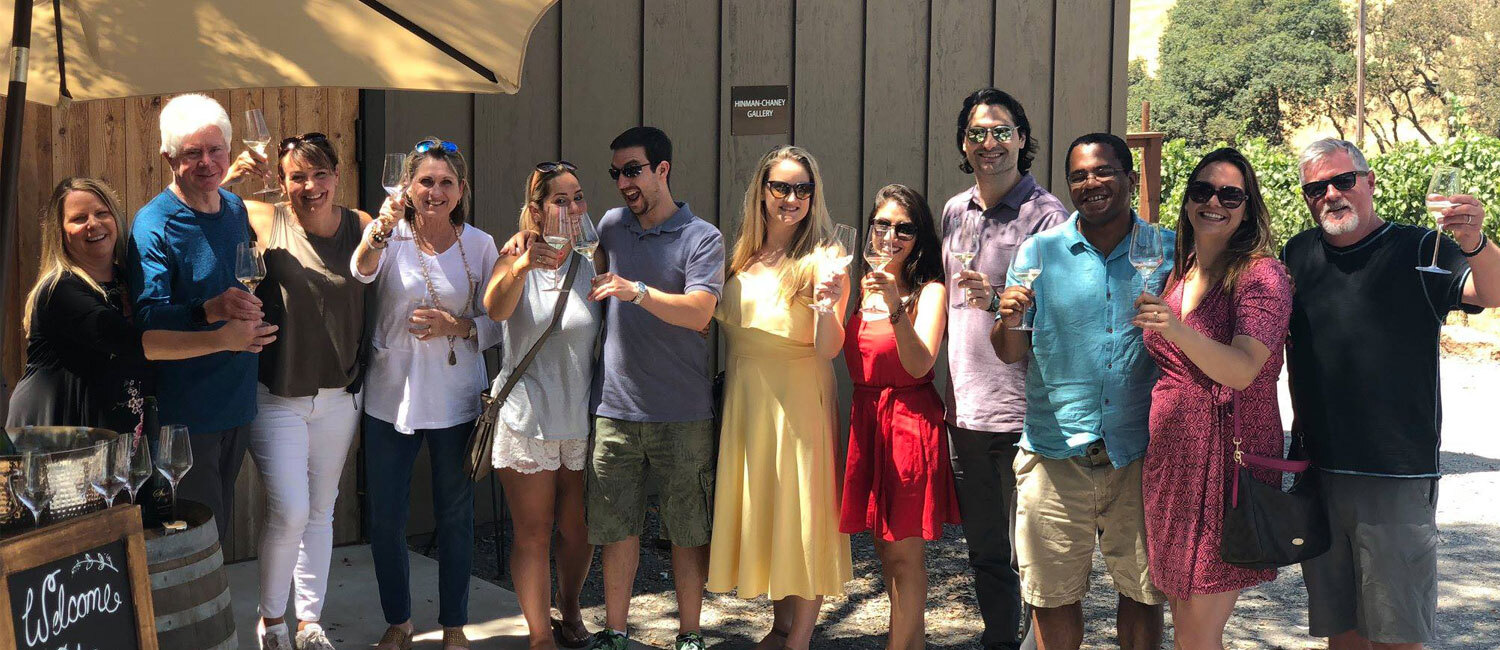 Group of friends cheering outside the tasting room