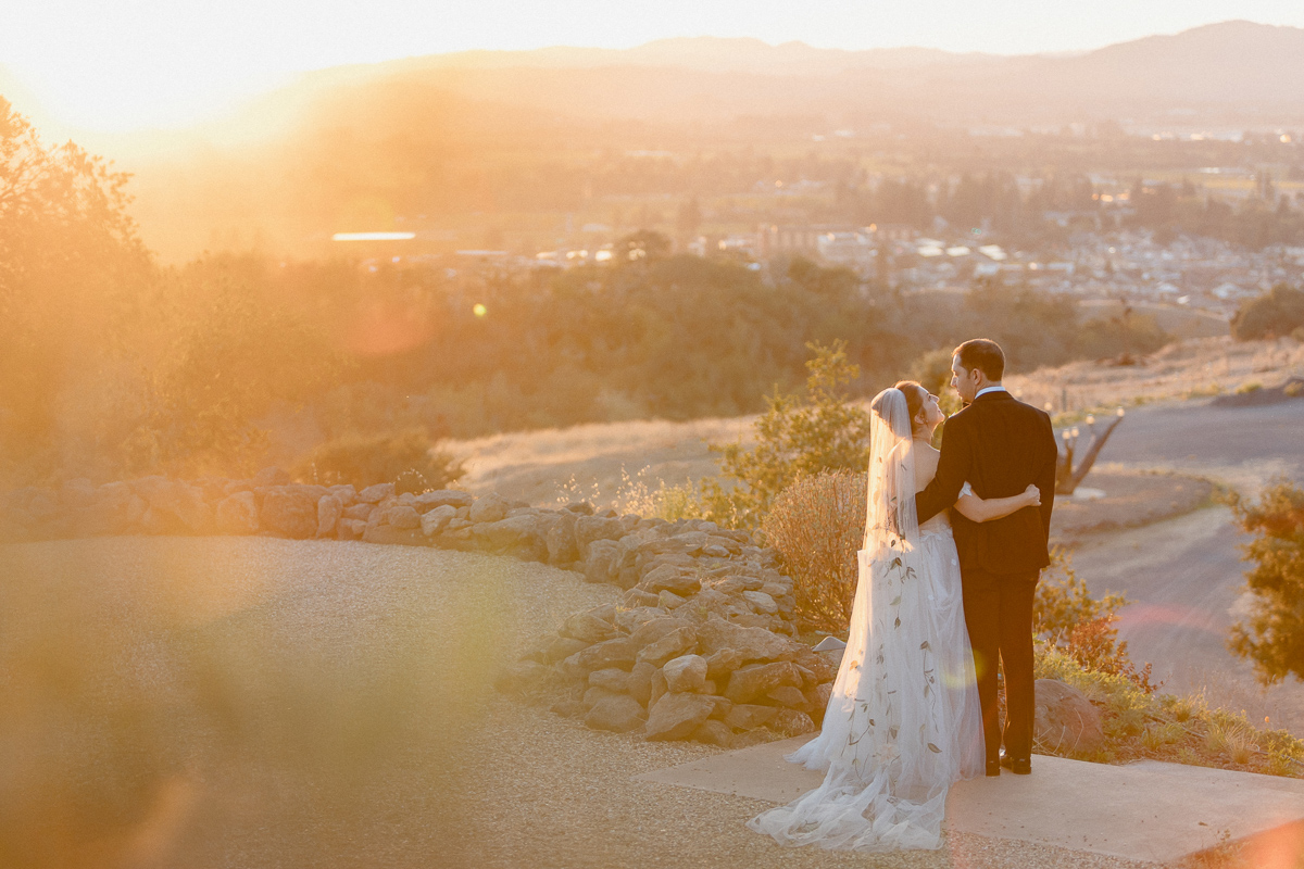 wedding couple taking photos at paradise ridge winery overlook