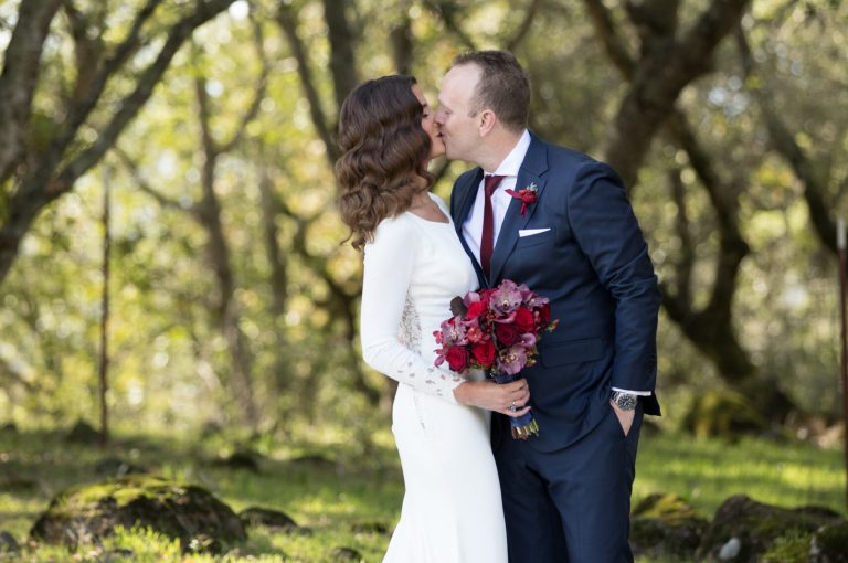 Bride and Groom kissing on the lawn at Paradise Ridge Winery