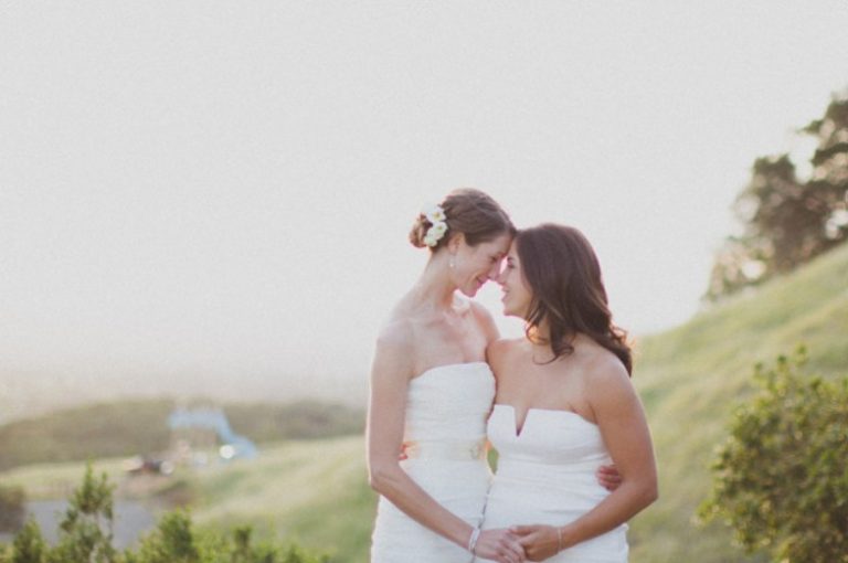 Two brides looking at each other at sunset